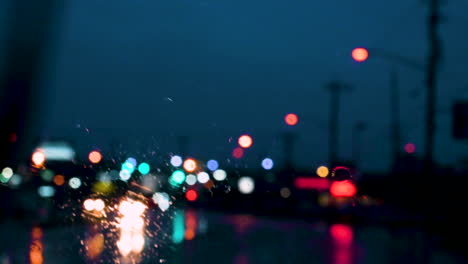 Colourful-Bokeh-street-lights-and-car-wiper-rain-drops-on-the-window