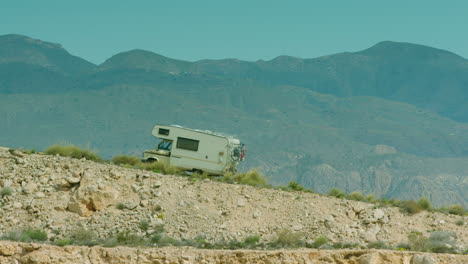 Stunning-shot-of-an-old-campervan-climbing-a-hill-in-Spain