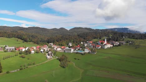 Aerial-view-of-Slovenian-village-Sentviska-gora-in-late-summer-day,-cloudy-sky