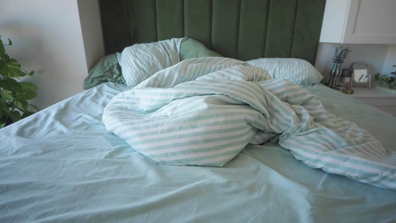Bedroom with Mint Green Linens and Striped Bedding