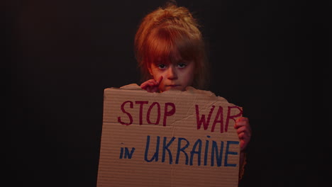 Homeless-girl-kid-showing-cardboard-massage-Hands-Off-Ukraine,-crisis-war,-no-peace,-stop-aggression