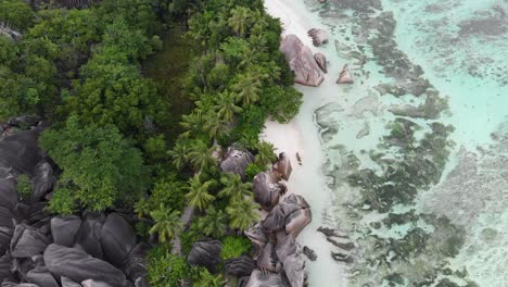 aerial view of anse source d’argent, la digue, seychelles shot in the early morning hours with no people on the beach