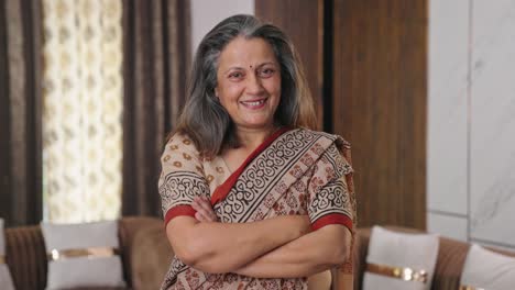 Happy-Indian-housewife-standing-crossed-hands