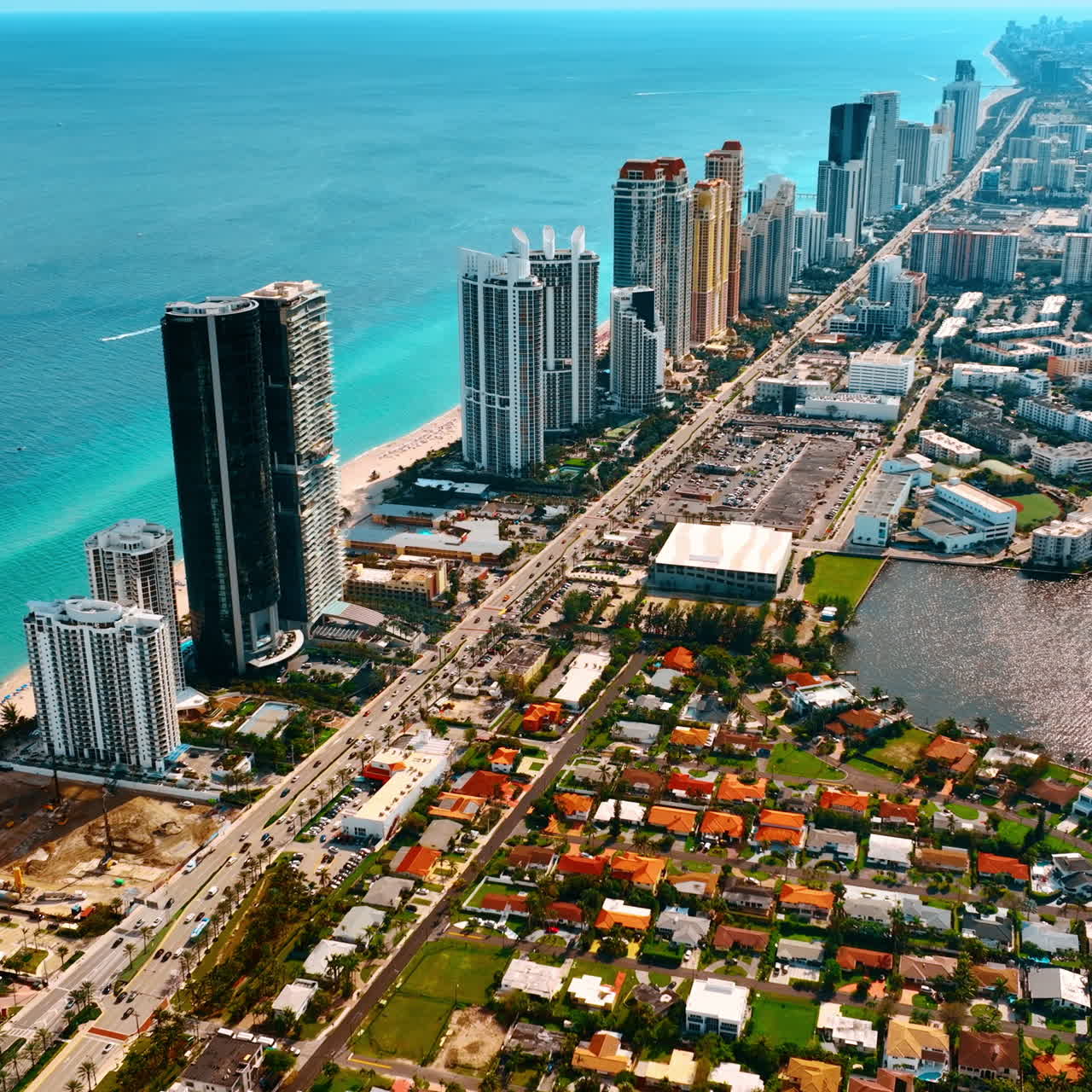 Splendid view of a luxurious Miami Beach. Amazing scenery of an area with gorgeous skyscrapers, low-rise buildings and azure waterscape. Top perspective.
