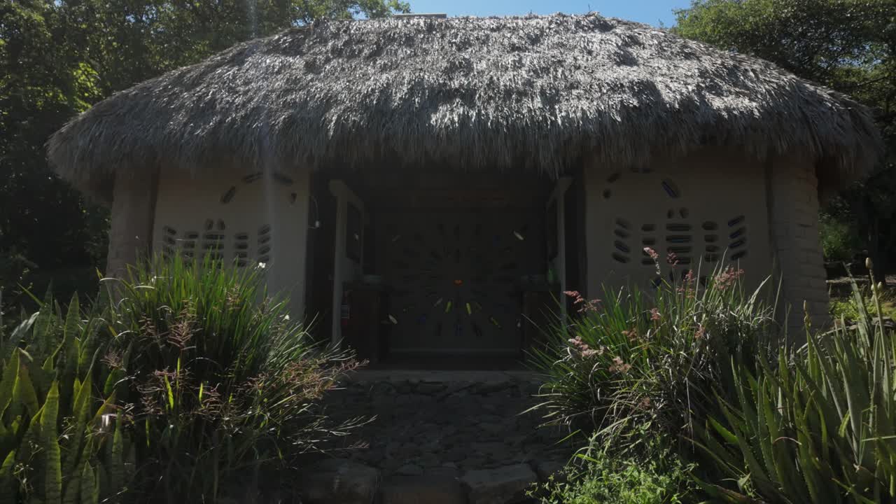 Exterior of mountain retreat in peaceful natural surroundings, showcasing rustic charm and tranquility, dolly to front entrance