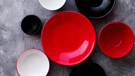 Collection-of-empty-colorful-decorative-ceramic-bowls-on-grey-stone-background