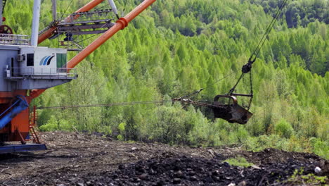 mining operation with excavator and cableway in a forest