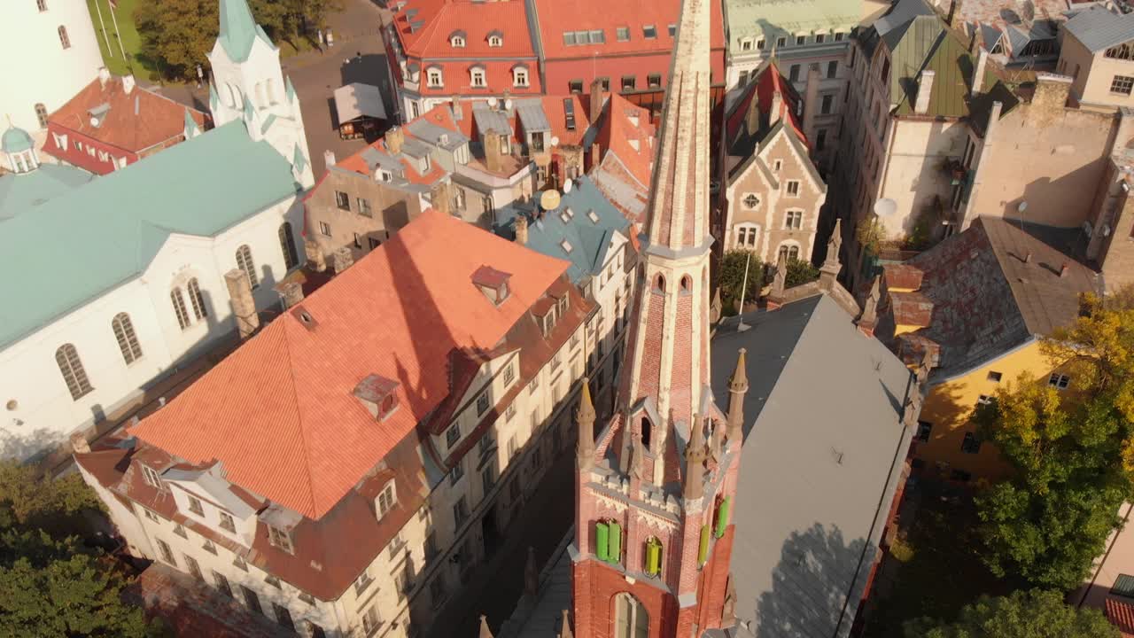 drone aéreo escénico inclinado hacia abajo sobre la torre de la iglesia anglicana de st saviors en riga, letonia, día