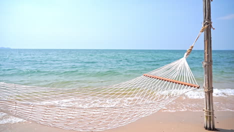 empty hammock net bed on tropical beach, luxury holiday concept