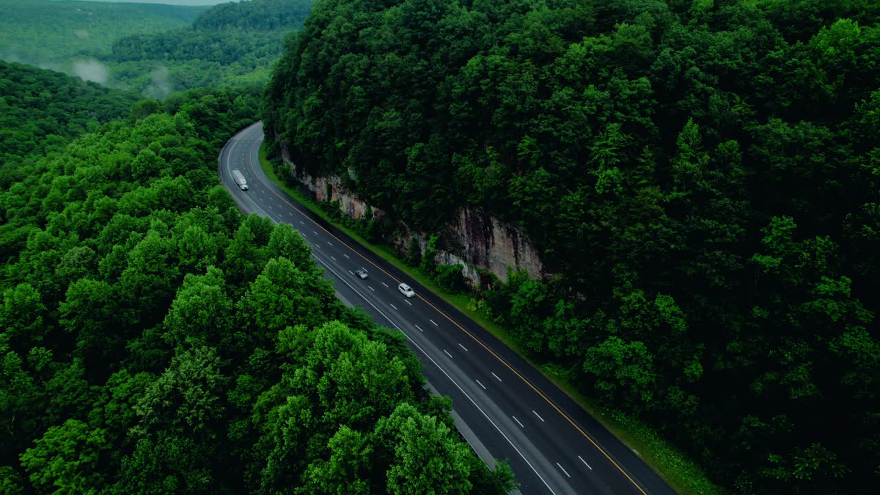 Forest Highway Rock Cut for Infrastructure Monitoring and Road Safety. Dry van semi truck in Tennessee