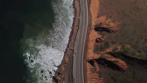 straight down bird's eye shot of traffic on coastal highway