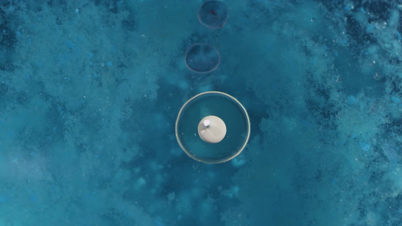 하 거품과 함께 파란색 얼룩질의 액체 텍스처. 매크로 추상적인 배경