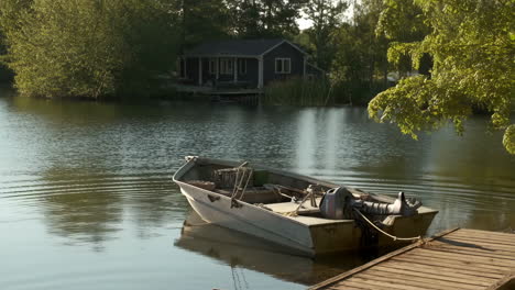 rustic boat docked at a lakeside cabin