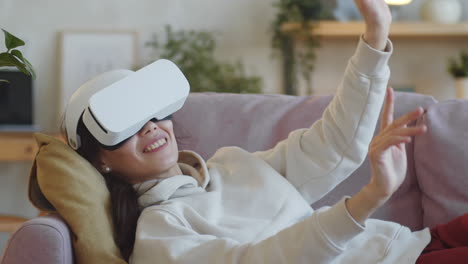 cheerful woman using vr glasses at home