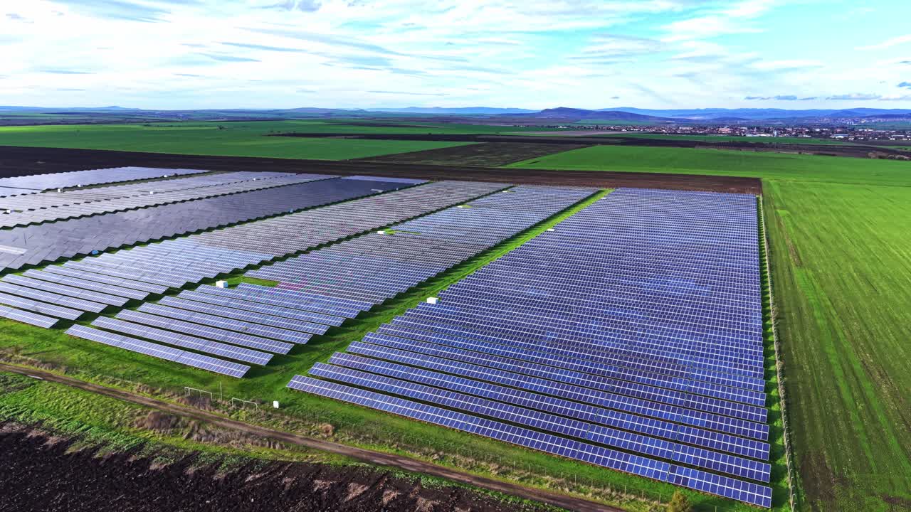 Solar panels cover vast fields in sunny agricultural landscape