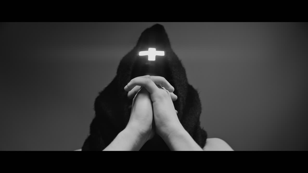 Masked man with cross of light glowing on his face moves his head up