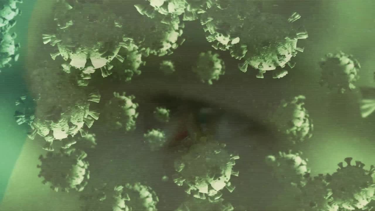 인간의 머리 위를 날아다니는 코로나19 세포의 애니메이션