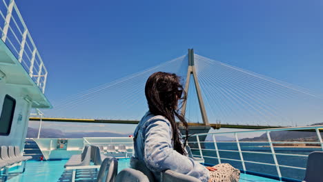 Rio-bridge-approaching,-solo-traveller-female-enjoy-ferry-ride,-Greece-travel