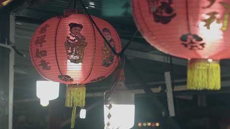 paper-lanterns-with-pictures-hang-under-Asian-cafe-ceiling