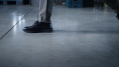 storehouse worker legs walking in manufacture storage employee at workplace