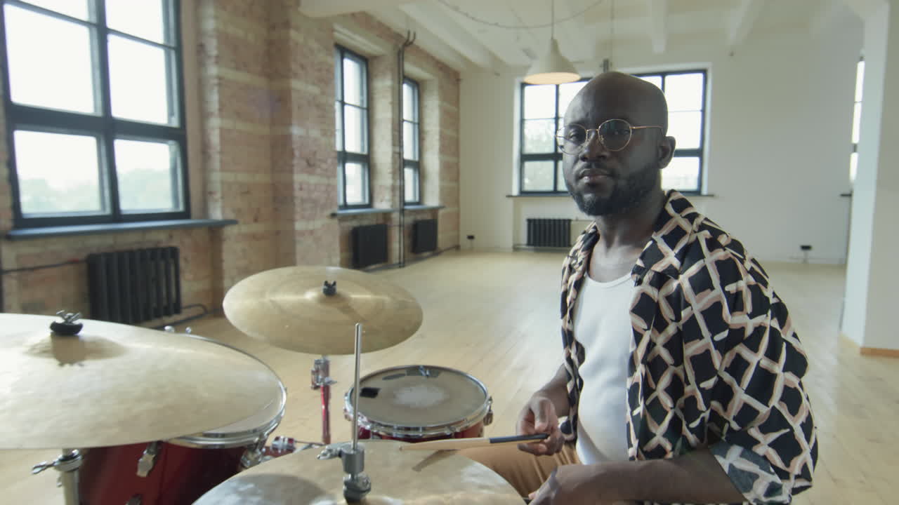 Portrait of Black Drummer at Drumset in Studio