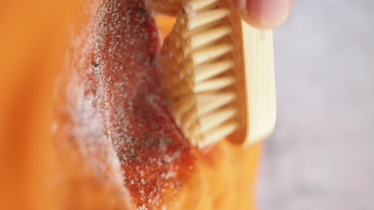 Cleaning fabric with a brush