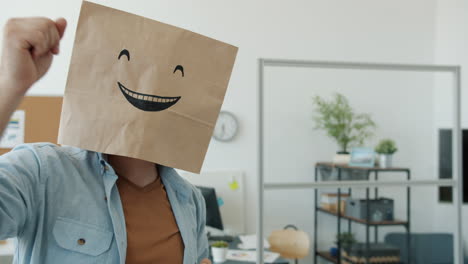 man wearing paper bag on head dancing