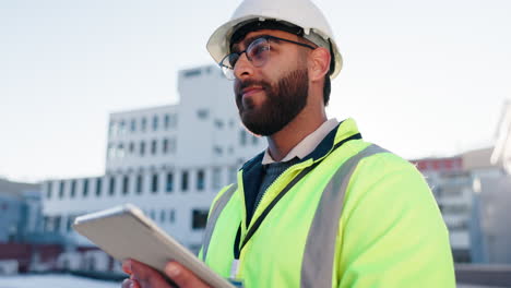 construction worker using tablet on rooftop