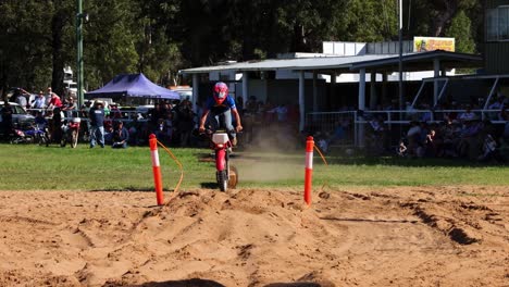 rider performs jump over dirt mound