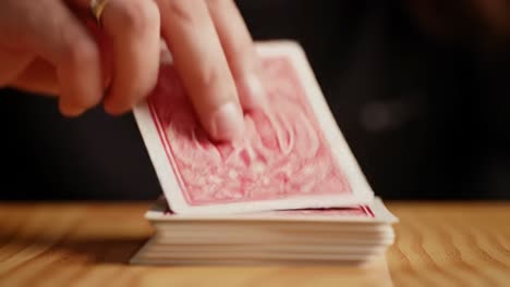 delicate manipulation of playing cards: an intimate glimpse into the art of card stacking captured in two frames highlighting expert skills in action
