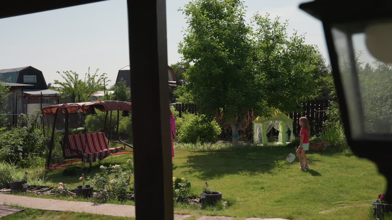 Suburban Yard Scene With Children Playing, Peaceful Afternoon In Garden With Family And Reflective Glass, Serene Scene Of Mother And Daughter In Garden During Quiet Suburban Afternoon