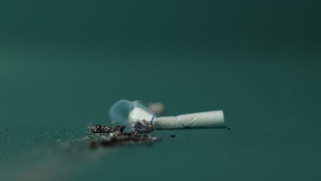 hand stubbing out a cigarette or joint