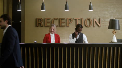 hotel receptionists welcoming guests