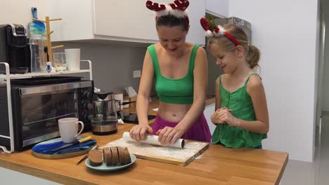 mother and daughter baking christmas cookies