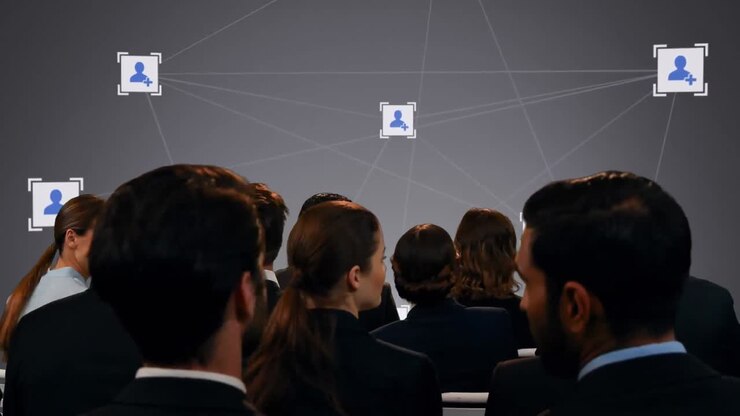 Animation of network of digital people icons over group of business people
