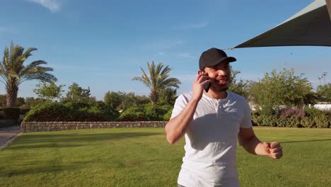 man talking on phone in a park
