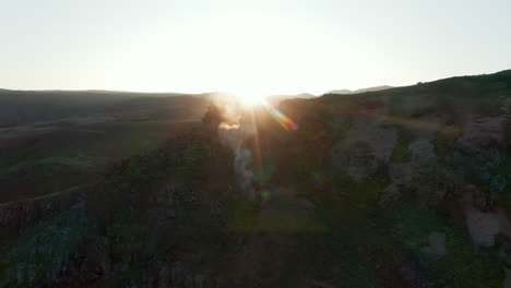 Sunset-over-geothermal-rocky-countryside-in-Iceland.-Aerial-View.-Birds-eye-flying-over-icelandic-stunning-moonscape-highlands.-Beauty-in-nature