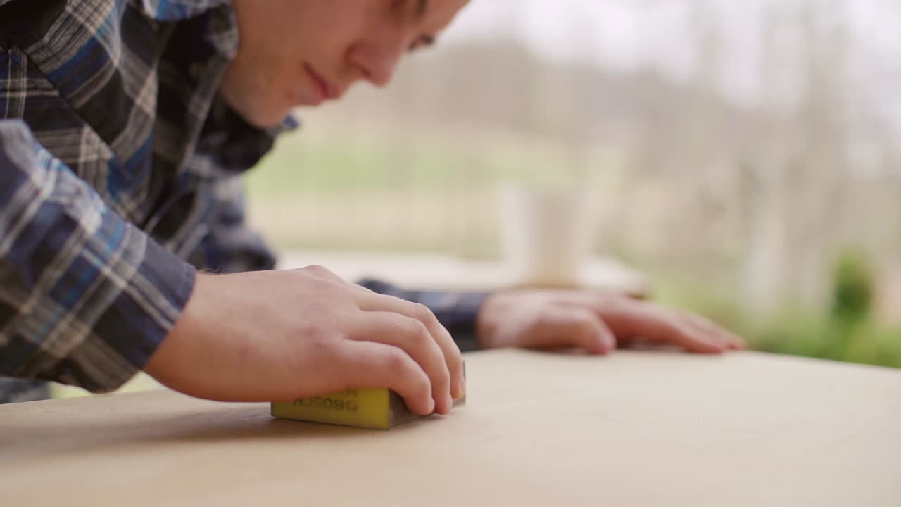 Man Sanding Wood Surface