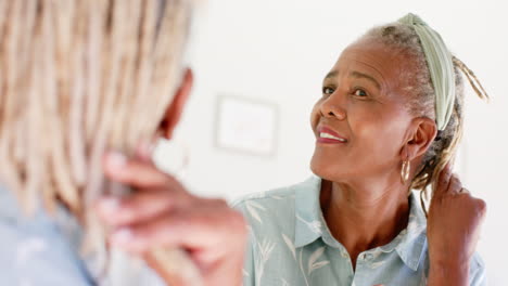 A-senior-African-American-woman-with-grey-hair-is-playing-with-her-dog