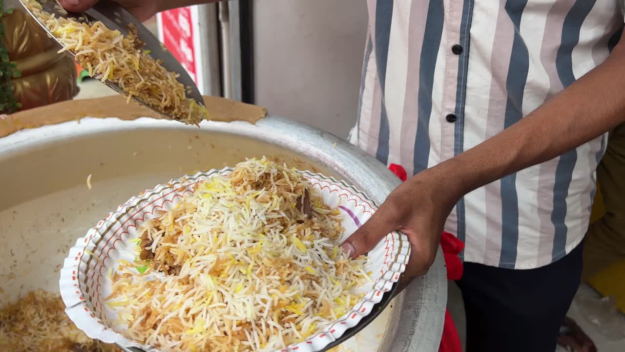 Kolkata style Mutton biryani being served in a paper plate in a shop in Kolkata.