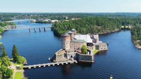 aerial view circling the olavinlinna castle, sunny, summer day in savo, finland