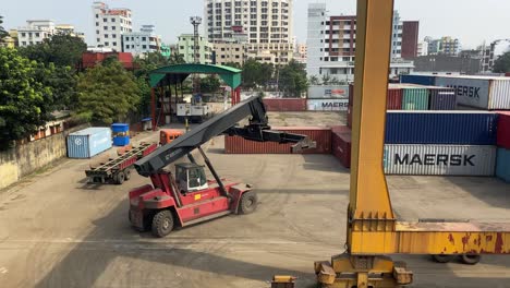 containers being moved around at dhaka inland container depot, bangladesh