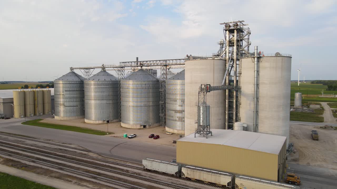 Grain elevator and new modern silos, aerial ascend view