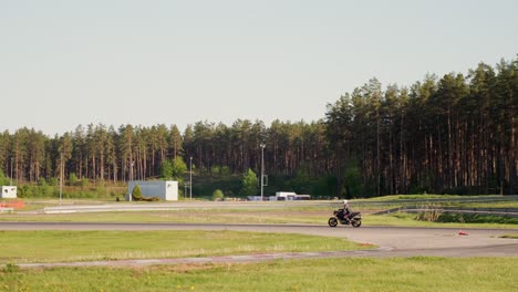 Pitch-black-Roadster-street-motorcycle-cruising-on-racetrack-corners-Europe