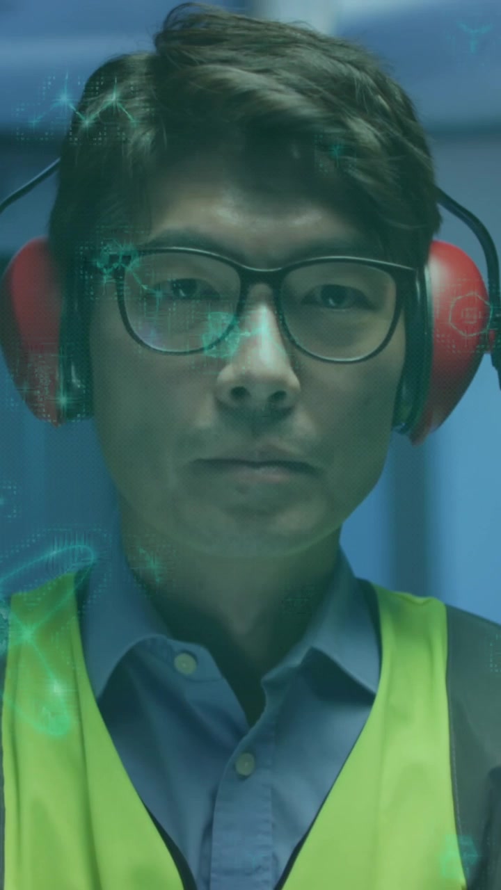 Asian Man in Safety Gear with Digital Overlay on Face