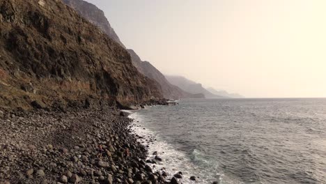 Idyllic-scene-of-two-people-at-unspoiled-virgin-beach-in-Gran-Canaria,-Spain-during-summer-time-on-vacations