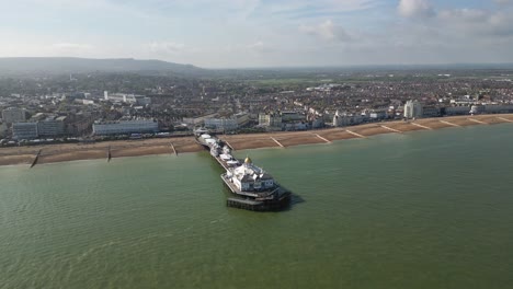 flying around eastbourne pier, sea front and beach.distant shot. video shot with dji mini 3 pro drone in eastbourne england. 4k video
