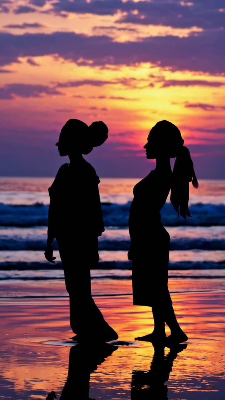 Silhouettes of Two Women on a Beach at Sunset