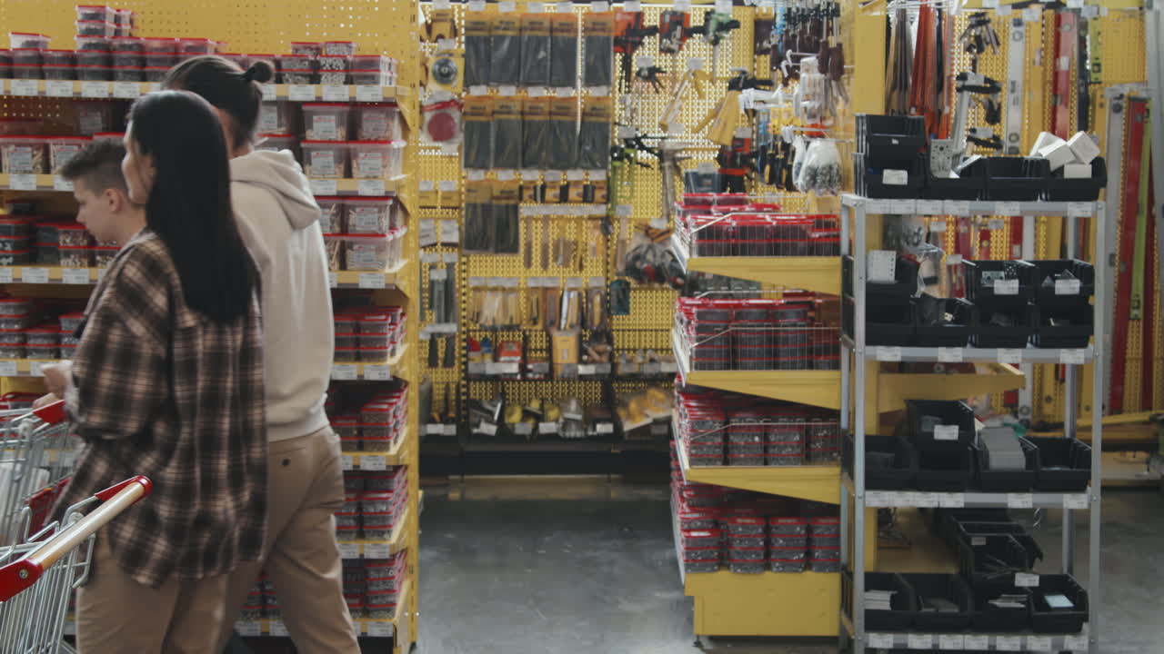 Family of Three Walking in Hardware Store