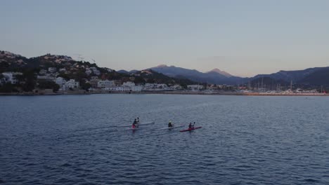 orbit around group of kayaks paddling in harbour of port d'andratx mallorca, aerial